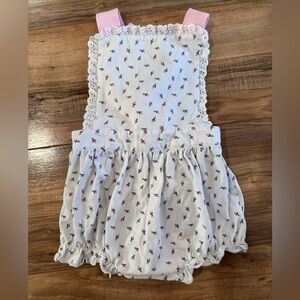 The smocking place size 2 girls romper with adjustable straps that tie behind.
